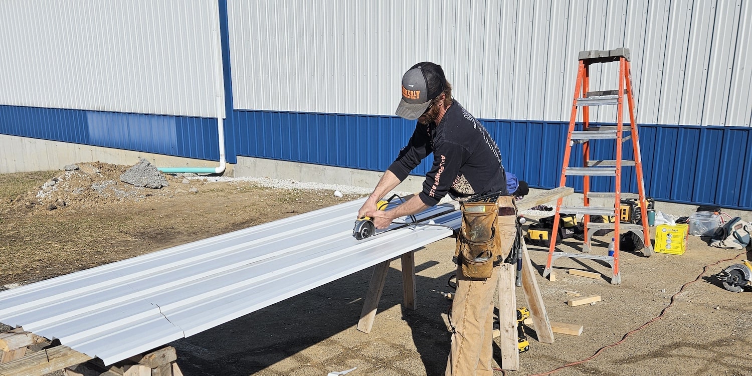 An employee cutting siding for a commercial project