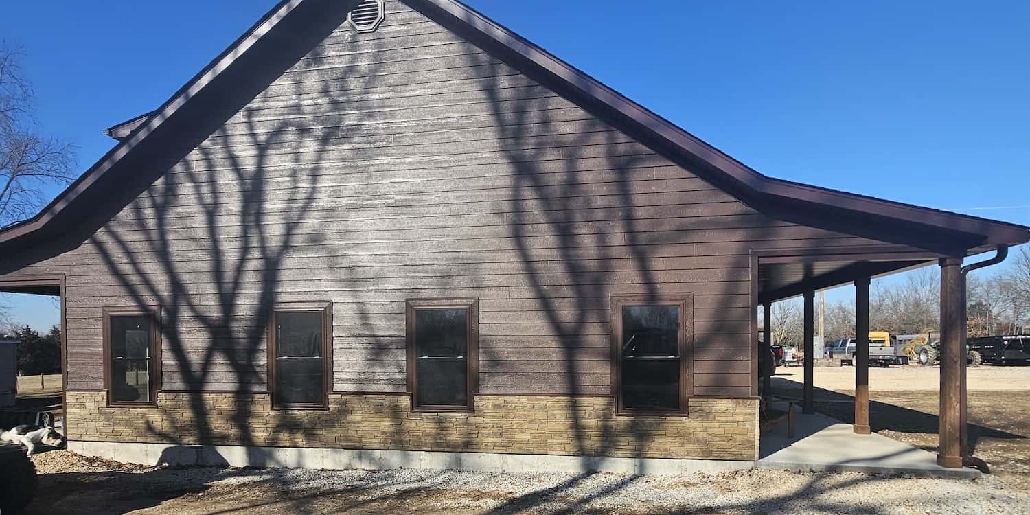 A newly built residential house with dark brown paneling