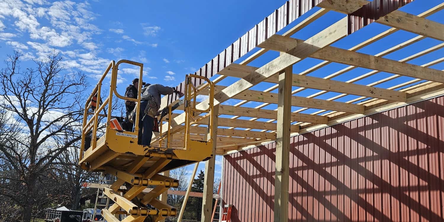 Two construction workers on scaffolding