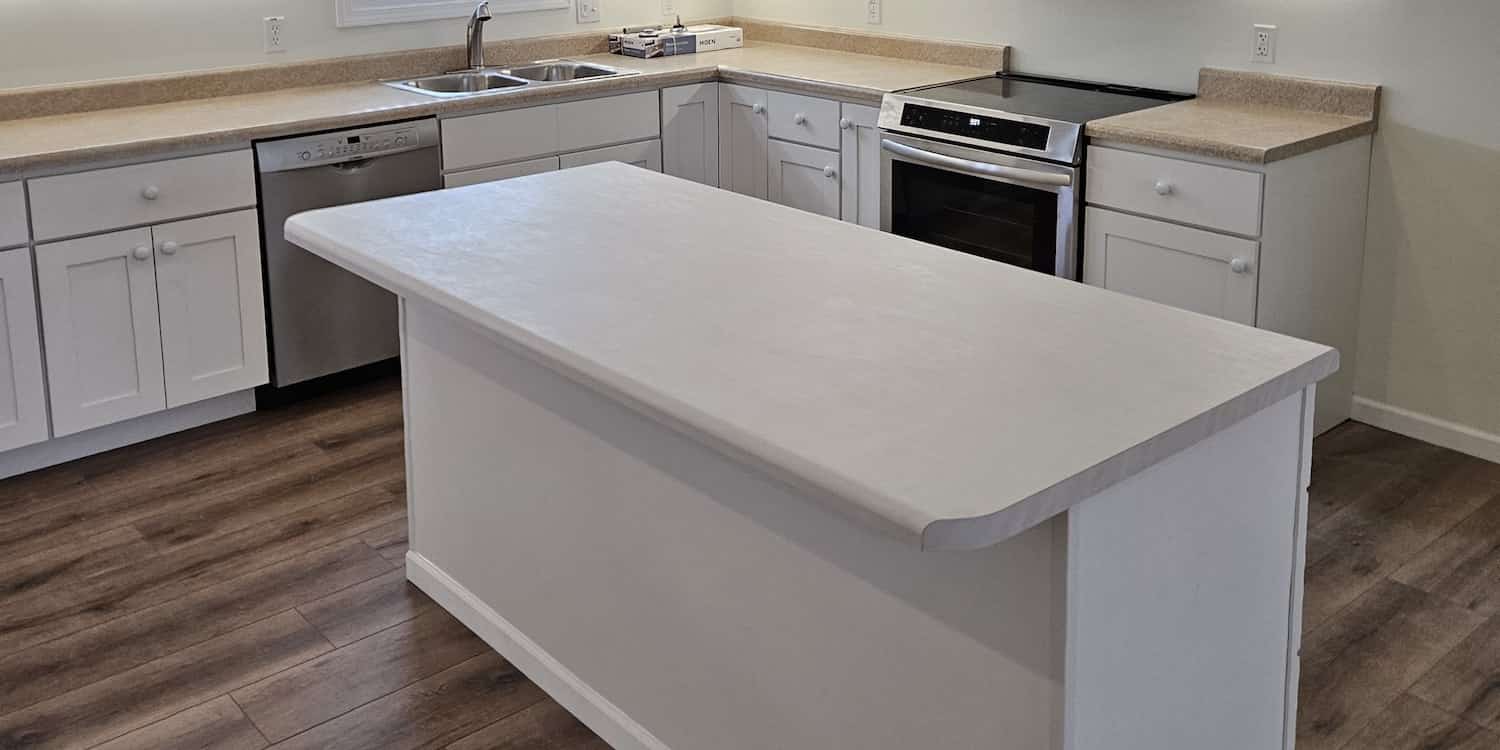 Kitchen renovation with white cabinets and white island