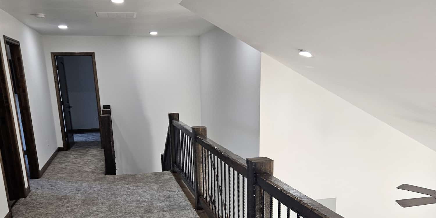 An upstairs hallway showing 2 bedroom doors